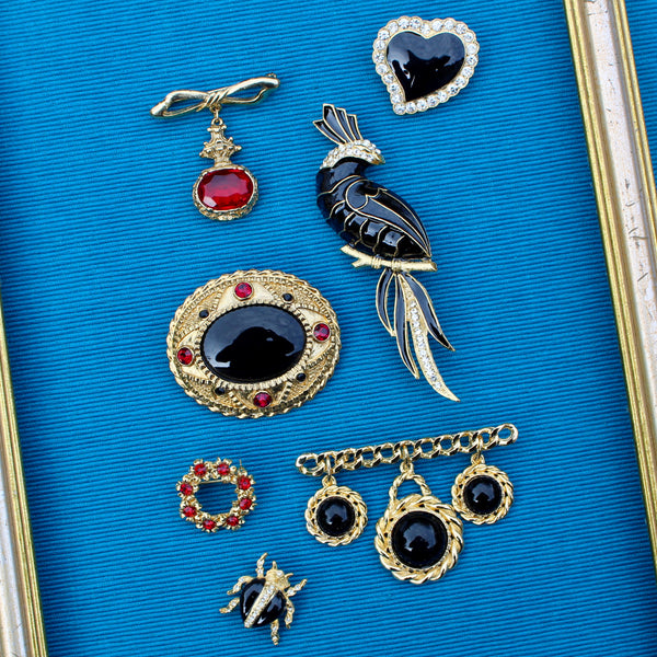 Black Oval with Red Brooch