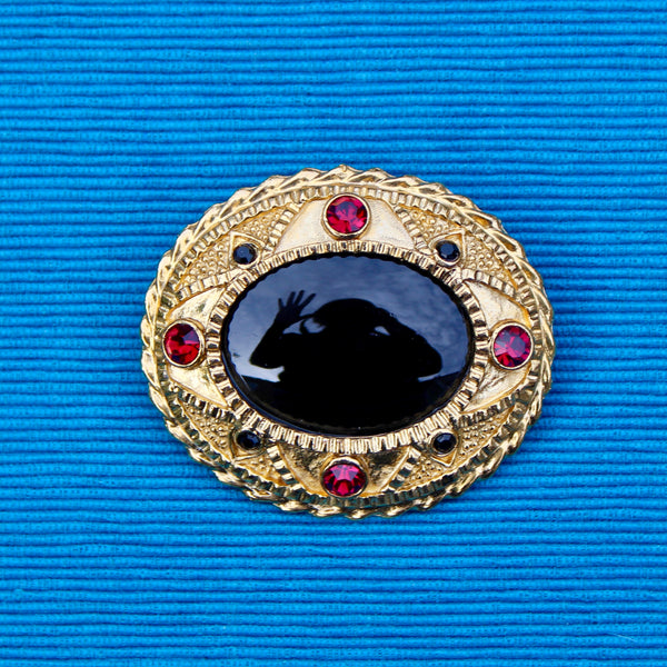 Black Oval with Red Brooch