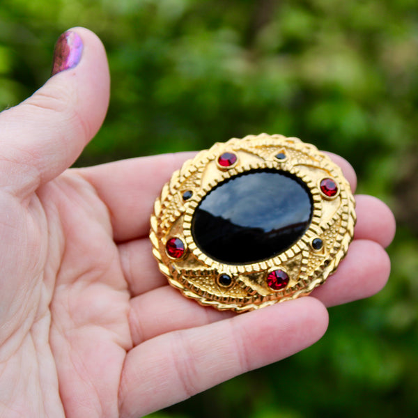 Black Oval with Red Brooch